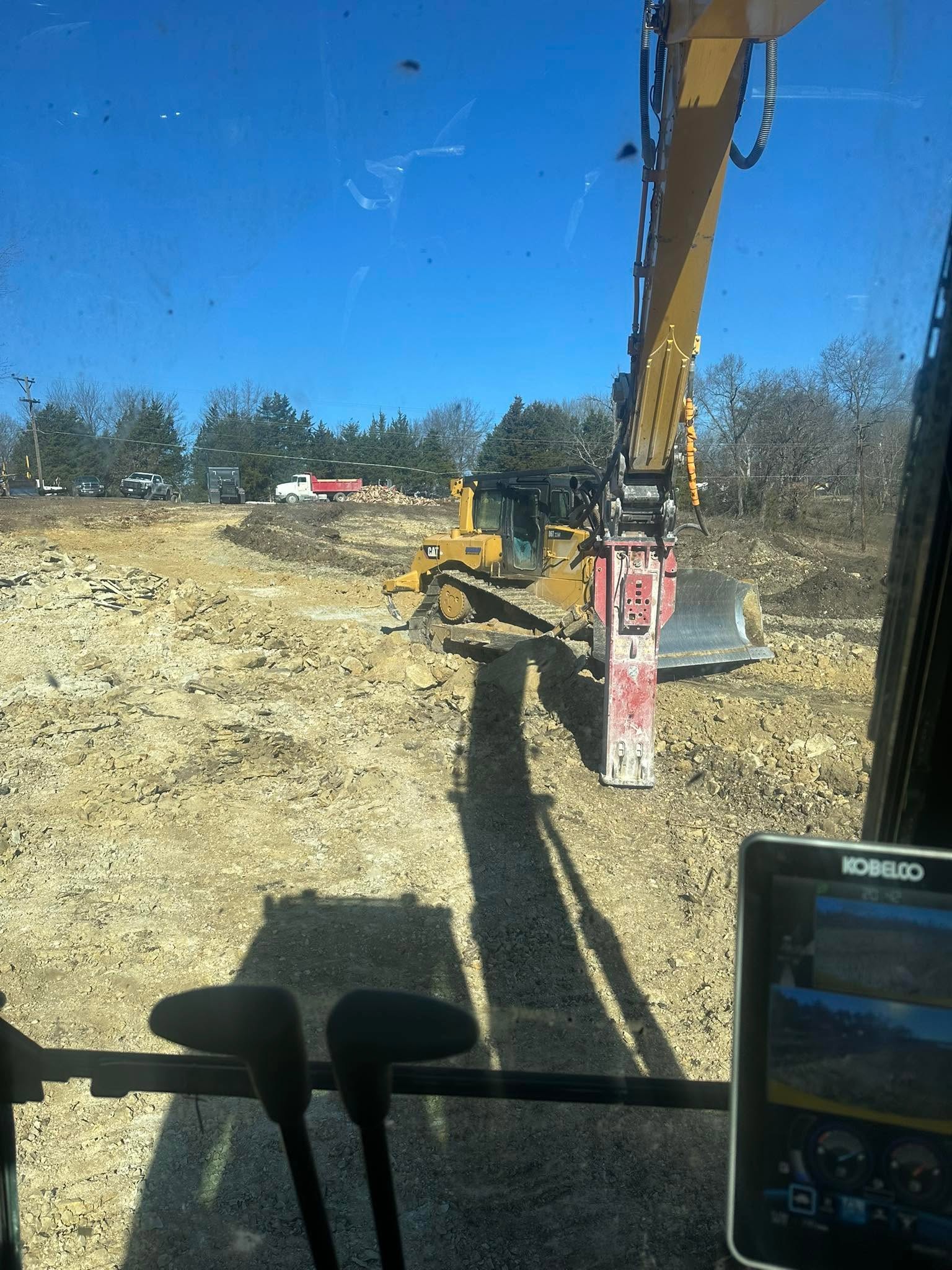 Excavator digging a residential pond in Henry County, Missouri