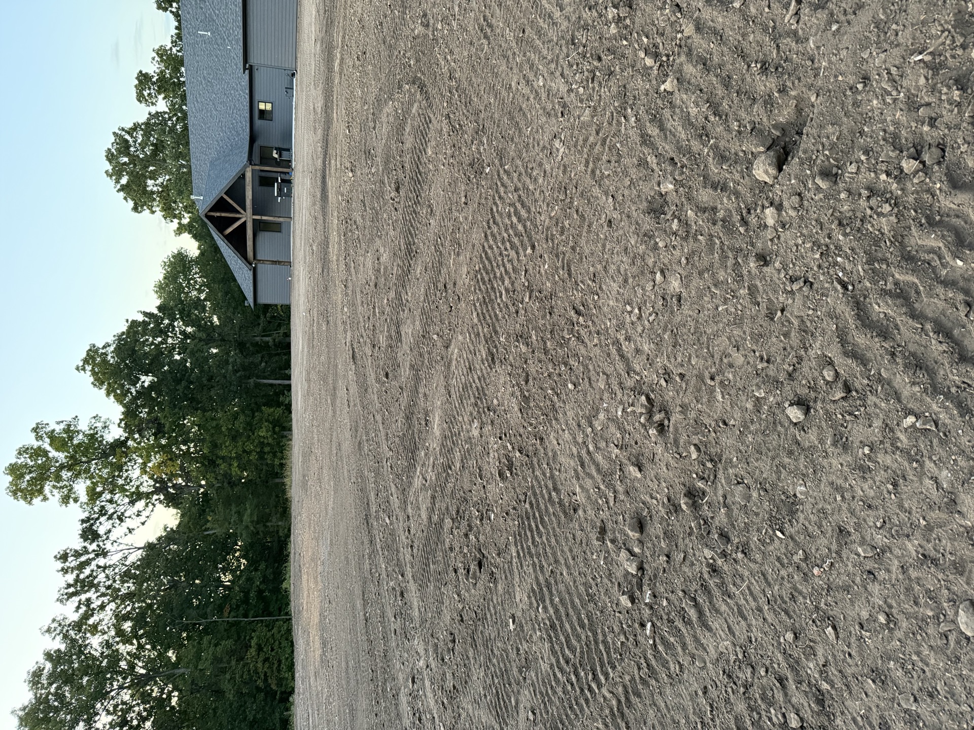Freshly graded building pad beside a new home near Windsor, MO