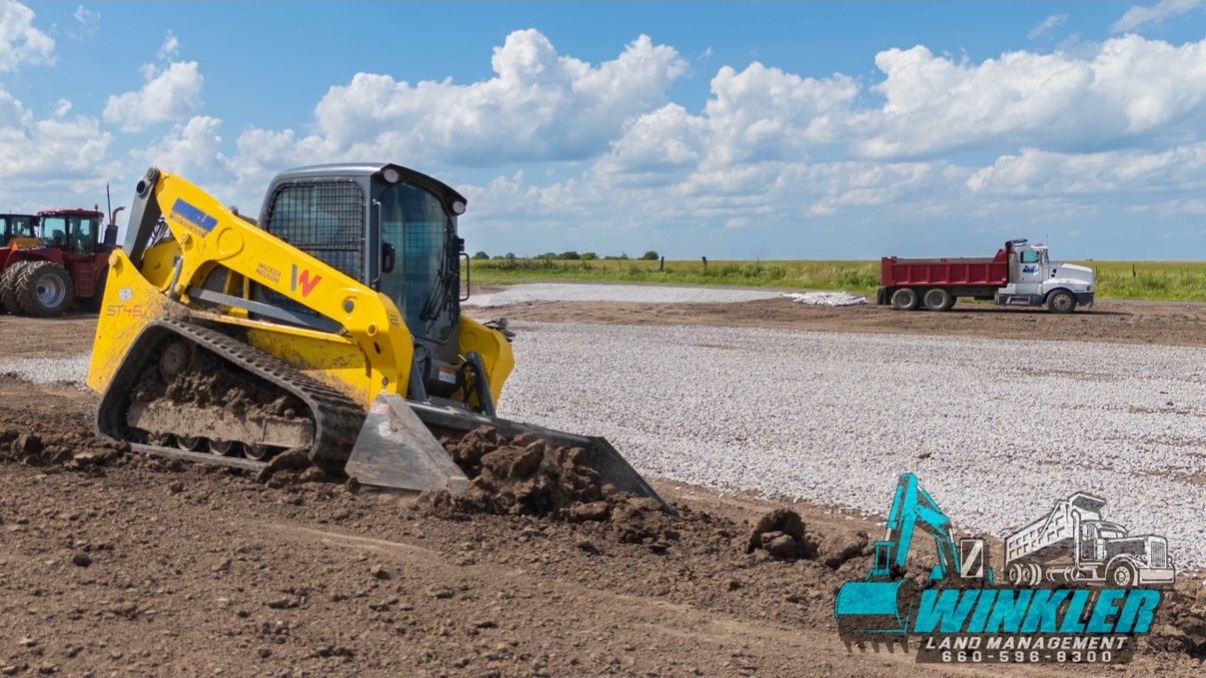 Compact track loader moving soil for site-prep near Windsor, MO